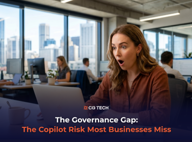 A business professional reacts with surprise at her laptop in a modern Australian office, representing the hidden data security risks businesses face when adopting Microsoft Copilot.