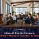 Team of business professionals collaborating on laptops in a modern office, discussing Microsoft's new Frontier Company AI announcement.